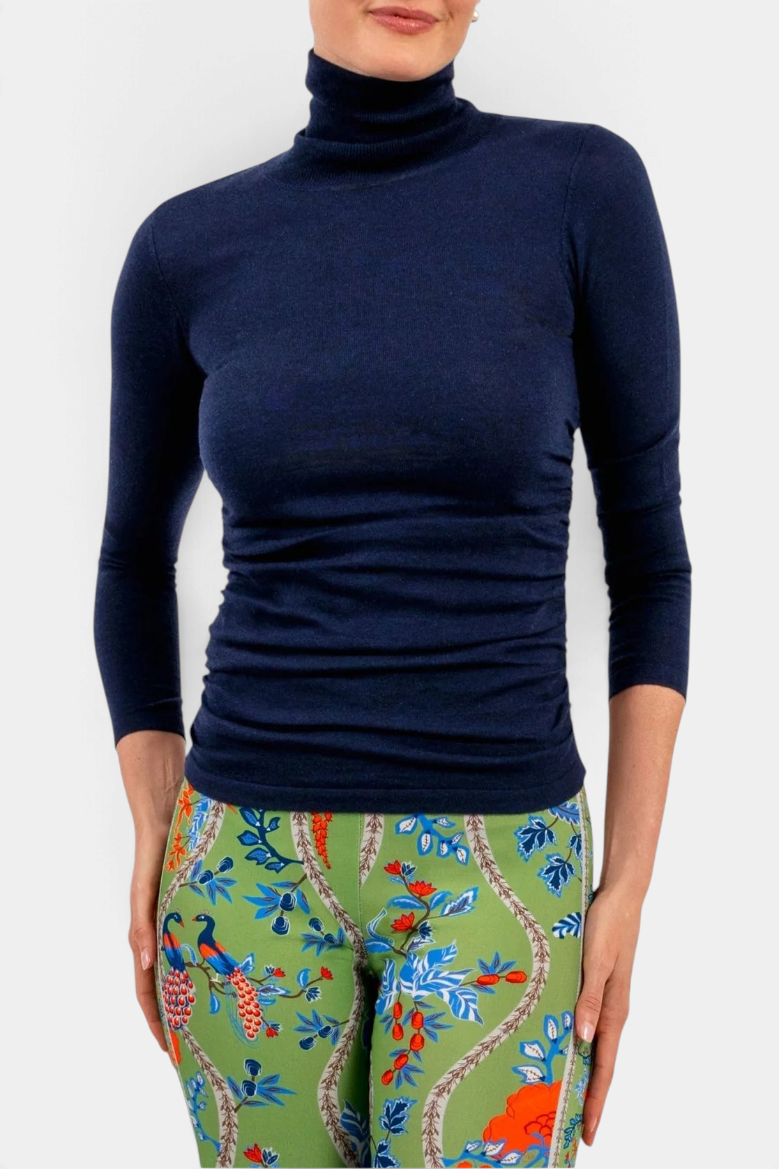 The Copper Shed navy blue cashmere turtleneck sweater with three-quarter sleeves worn by a woman.