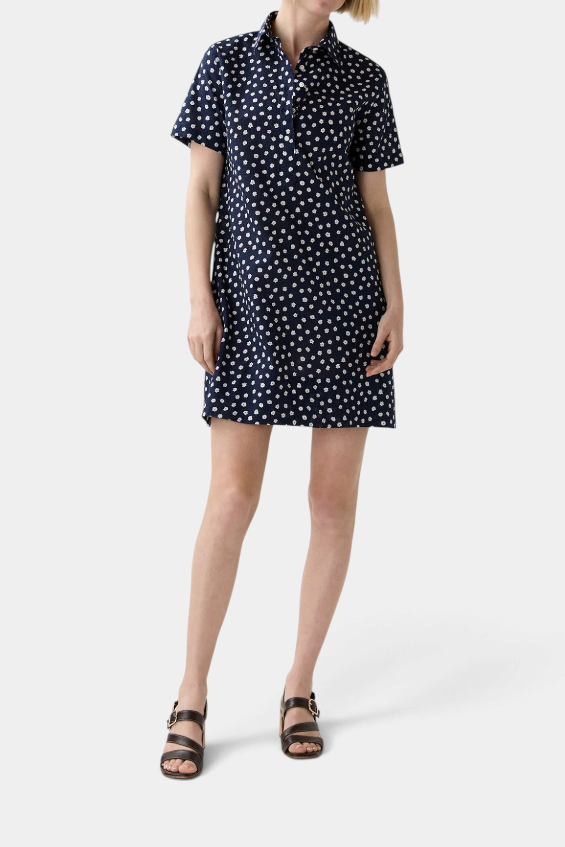 The Copper Shed navy blue short-sleeved popover shirtdress in crinkle cotton with a white daisy floral print.