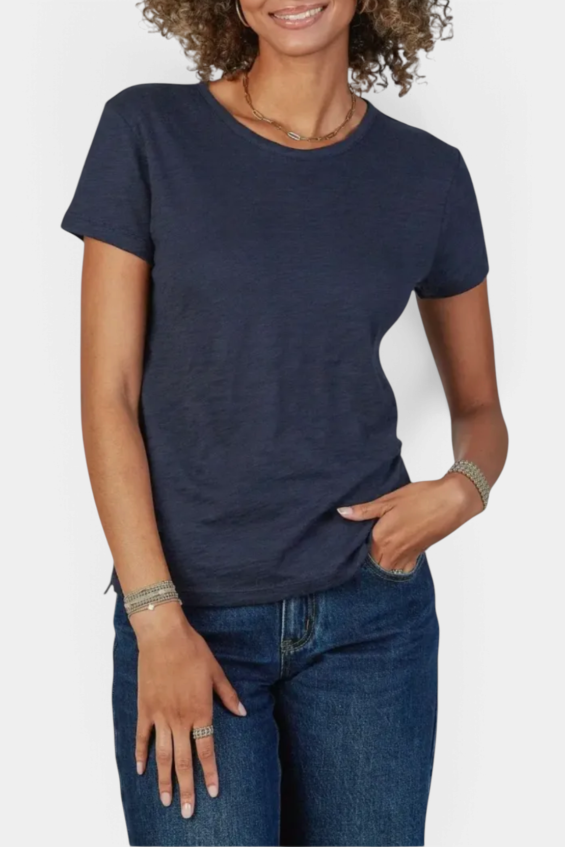 The Copper Shed navy blue pima cotton slub crew neck t-shirt worn by a woman with curly hair.