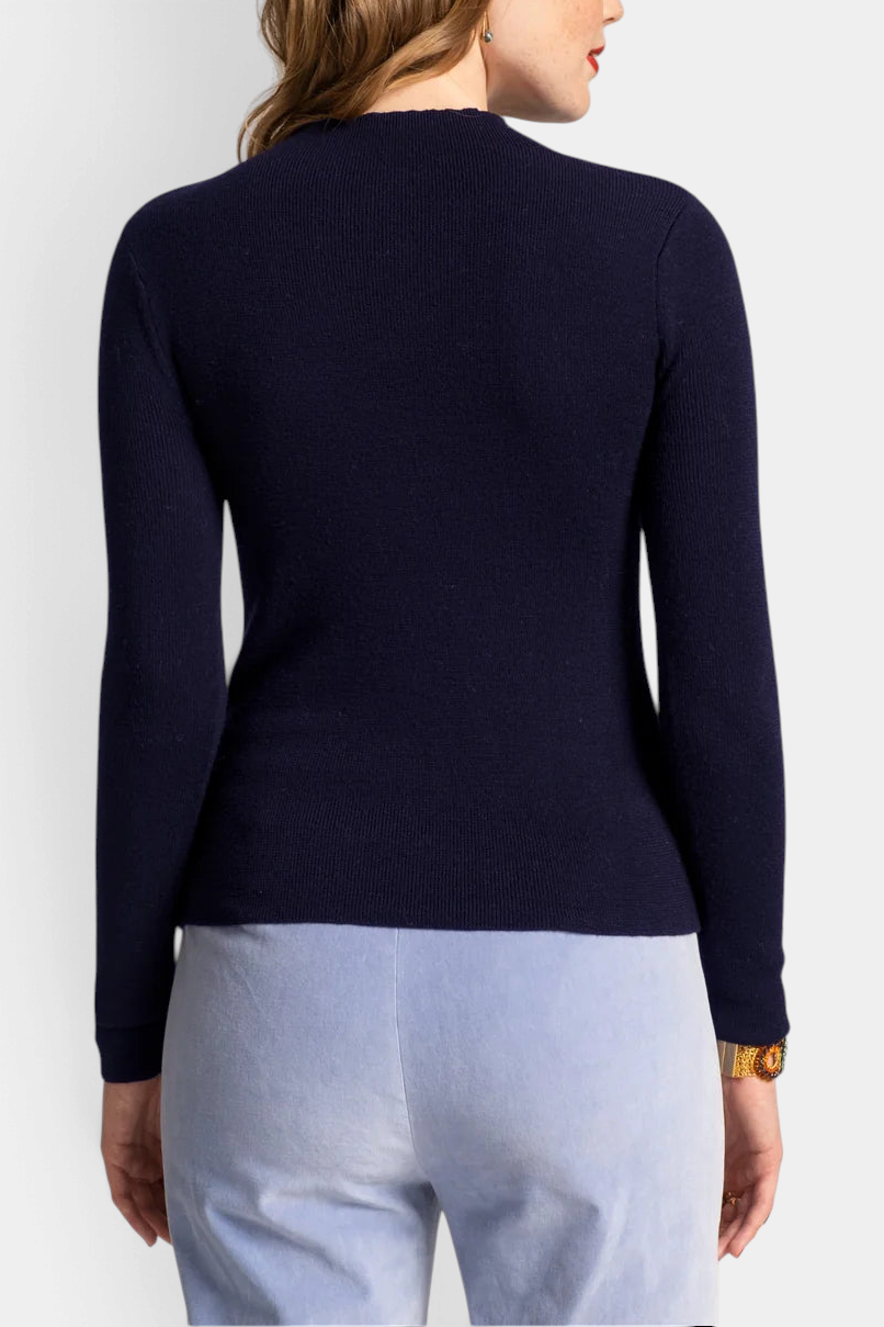 Back view of The Copper Shed Marie long sleeve navy blue rib knit cotton mock neck sweater on a model