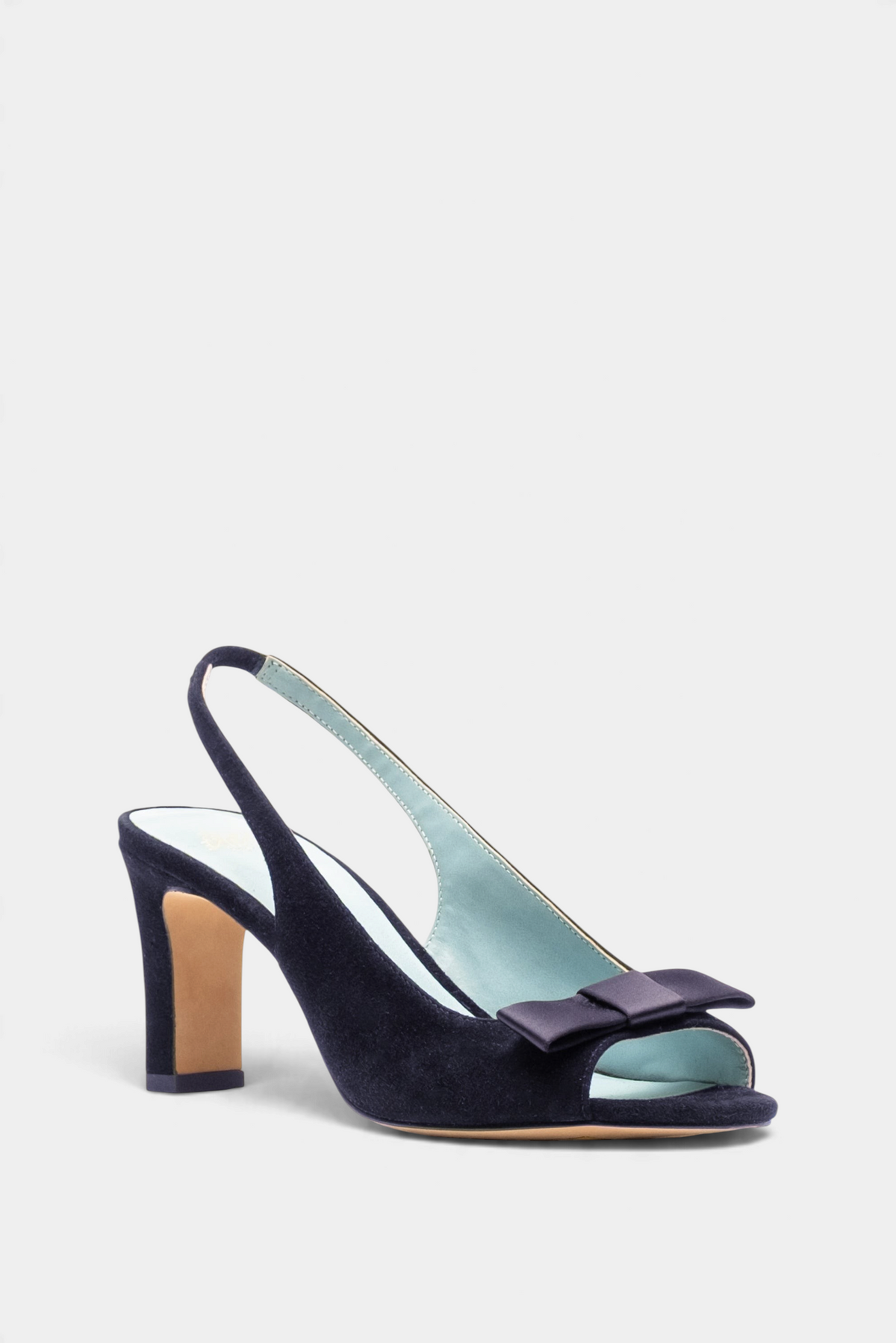 The Copper Shed navy suede Reese slingback heel with an open toe and elegant bow detail on the vamp.