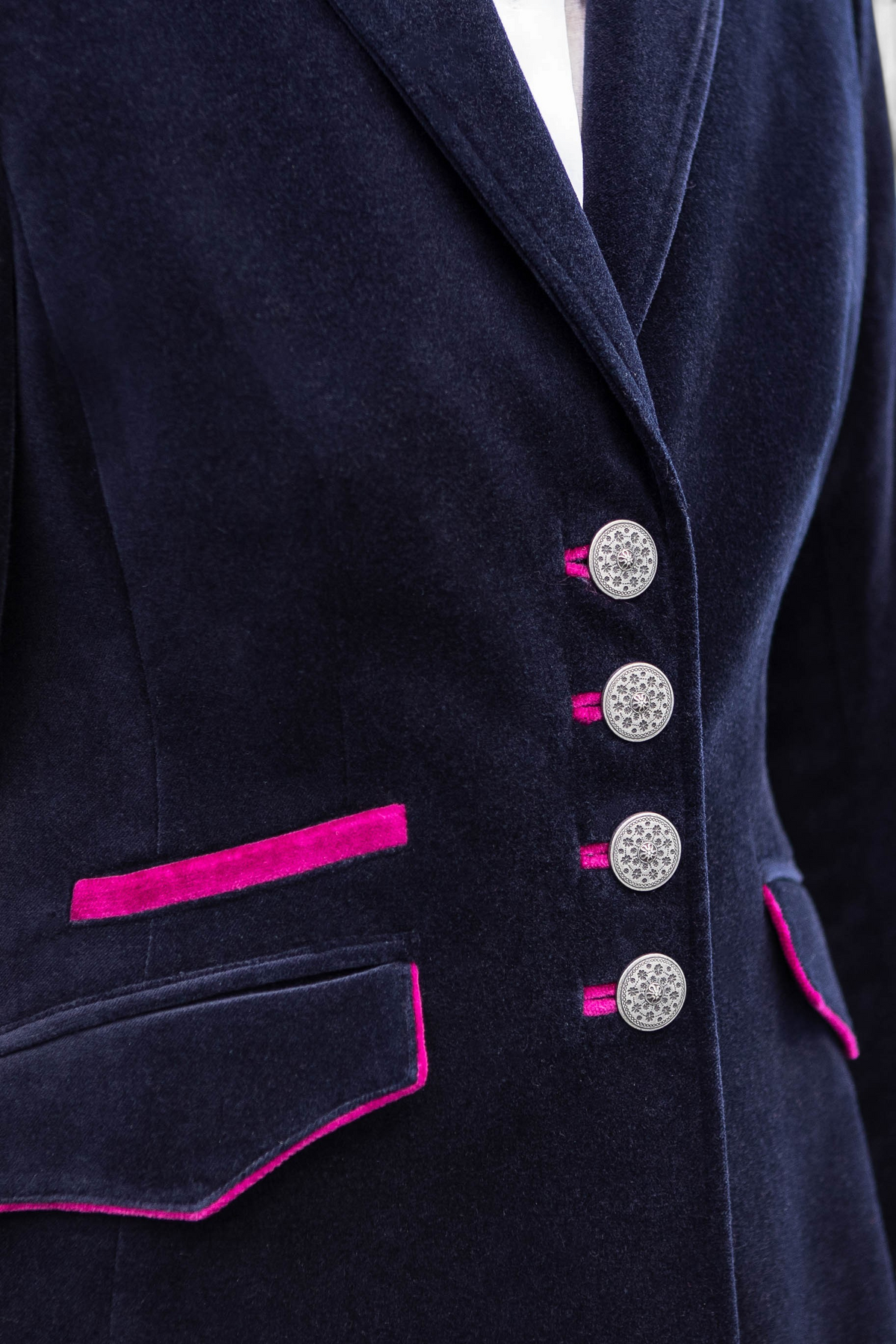 The Copper Shed Tamara Austrian velvet blazer in navy blue with vibrant pink trim and ornate silver buttons.