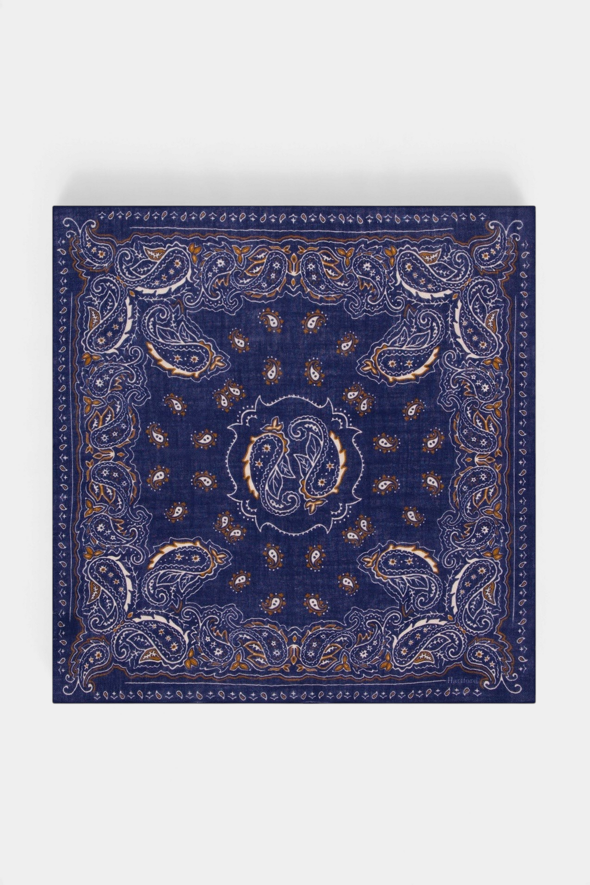 The Copper Shed navy blue wool square bandana scarf with intricate white and brown paisley print pattern