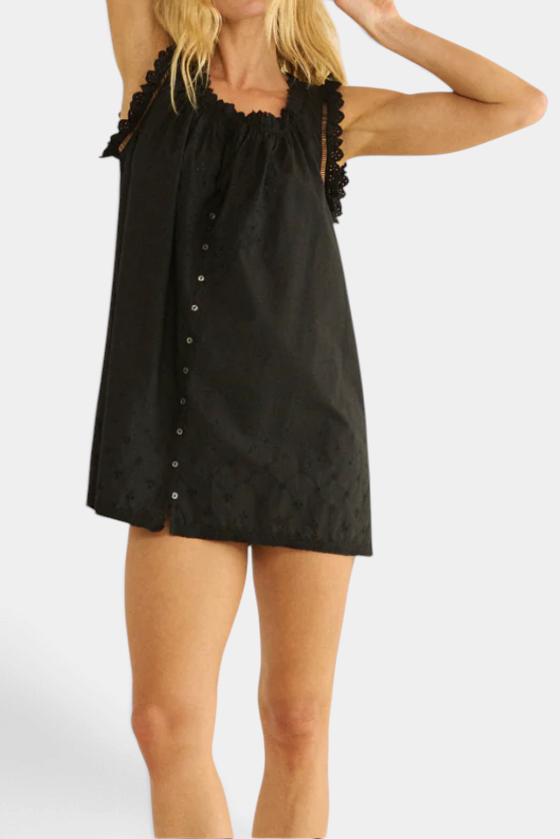 The Copper Shed Nessie Dress in black organic cotton poplin with eyelet embroidery, ladder trim, and button front.