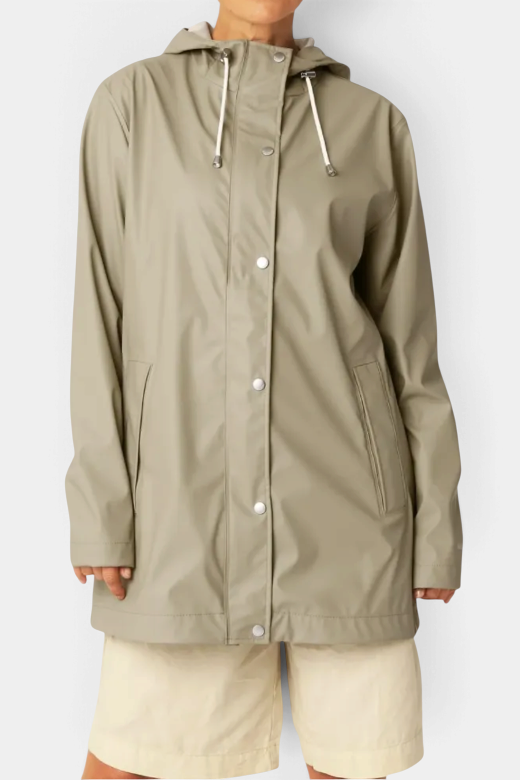 The Copper Shed light beige rubberized PU raincoat with a hood, snap buttons, and welded seams.