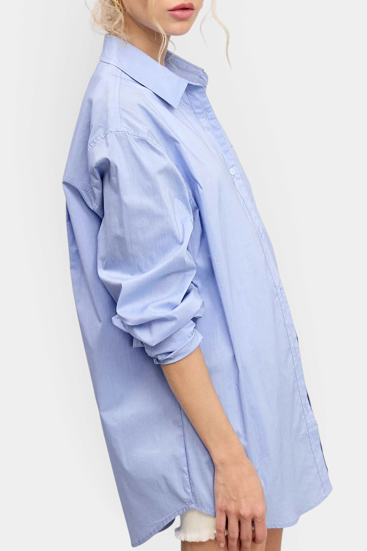The Copper Shed oversized light blue poplin button-down shirt with a classic collar worn by a woman