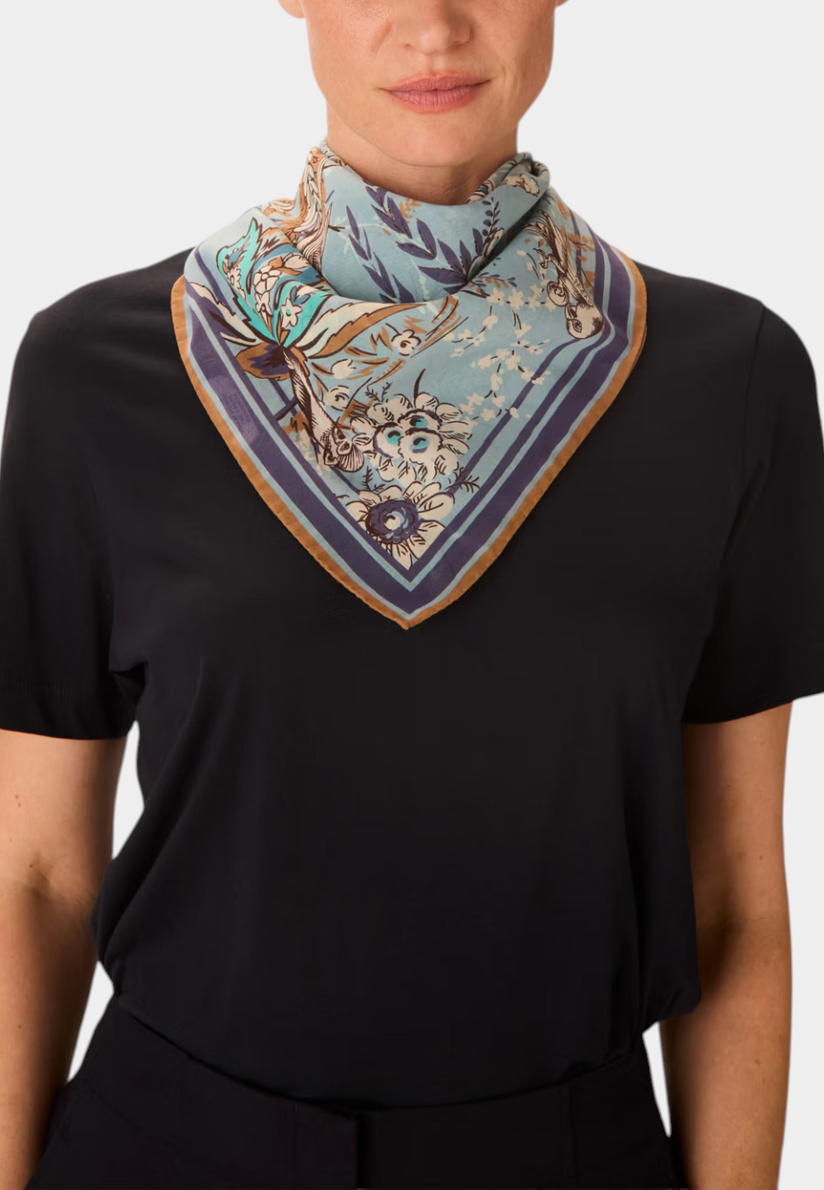 The Copper Shed Square 70 Pagode scarf in blue cotton with floral print worn around the neck