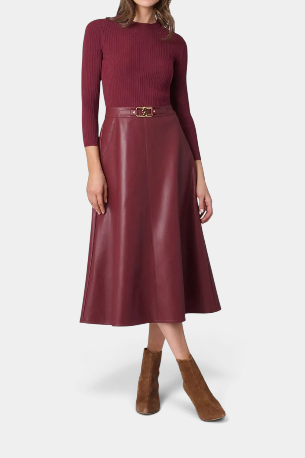 The Copper Shed Paige midi dress with a burgundy ribbed knit bodice and faux leather A-line skirt with buckle detail.