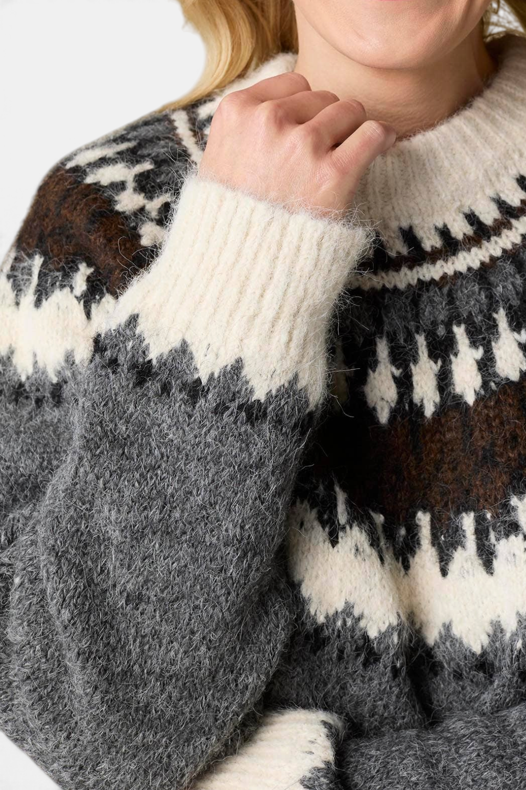 The Copper Shed Perissa mock neck sweater in a grey, brown, and cream Fair Isle knit pattern with ribbed cuffs.