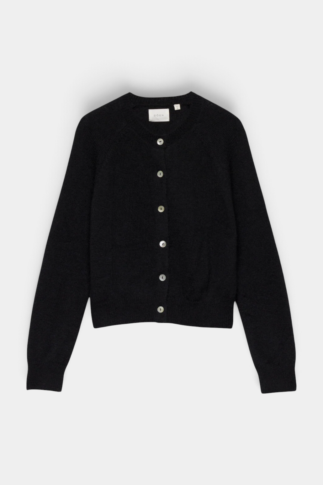 The Copper Shed Petra Cardigan in black alpaca and merino wool blend with a crew neck and shell button front.