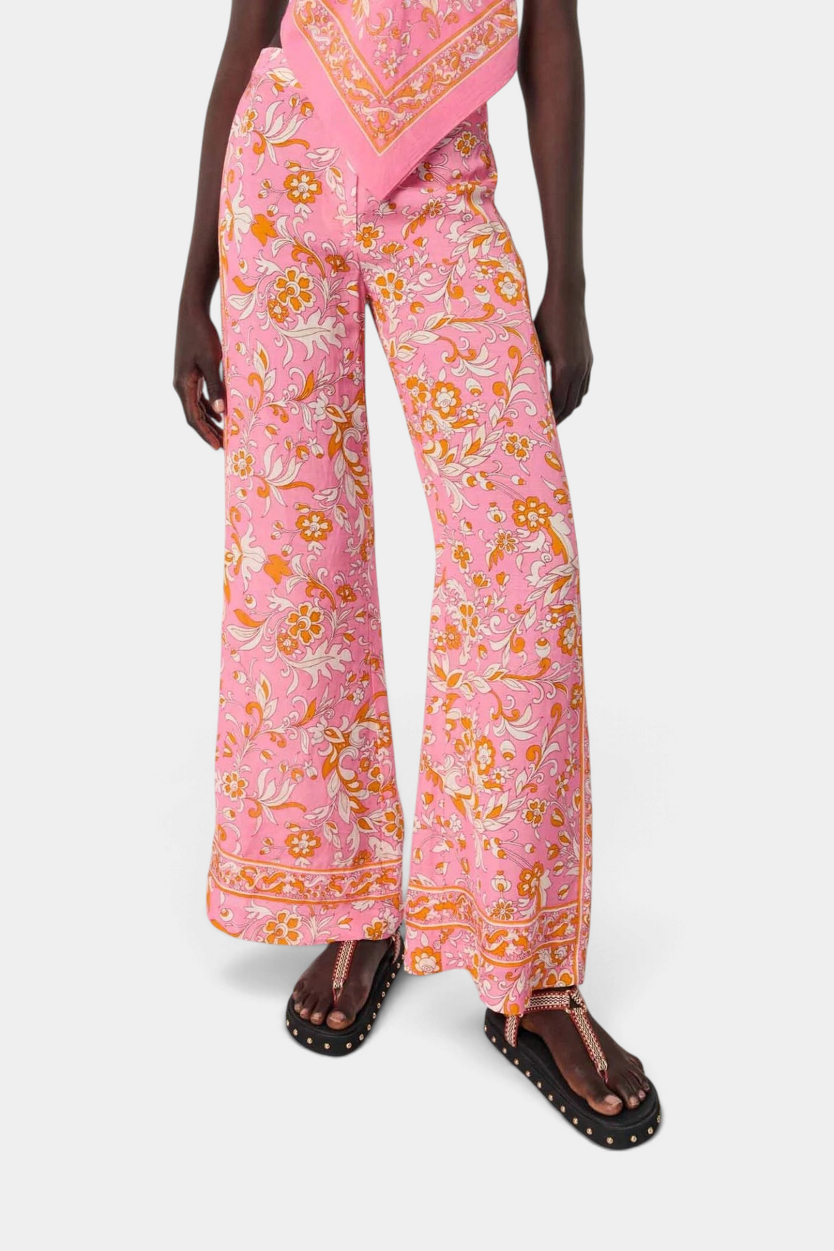 The Copper Shed wide-leg trousers in pink linen blend with a 70s-inspired floral print and elasticated back