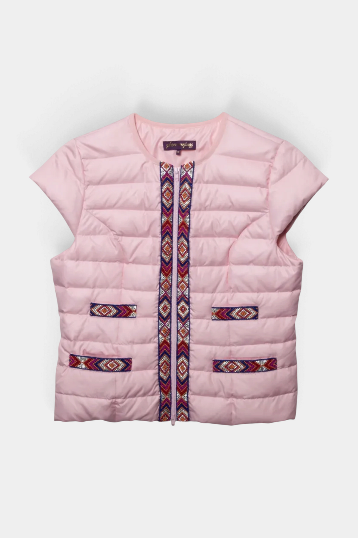 The Copper Shed light pink quilted vest featuring a sparkly Navajo-inspired geometric trim and zip-up front.