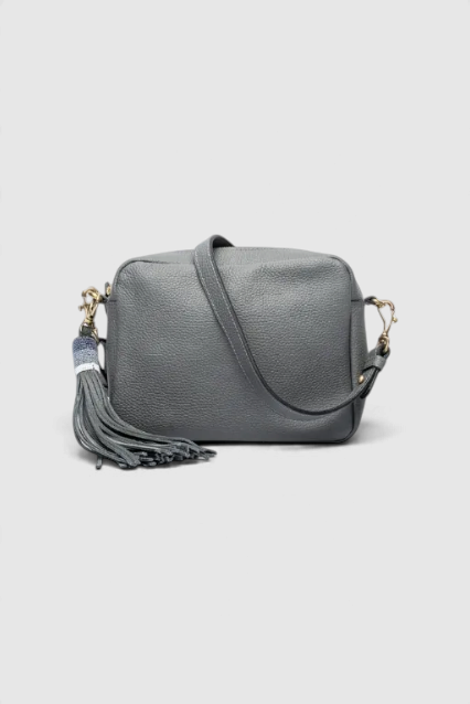The Copper Shed Princess grey leather crossbody bag featuring a long decorative tassel and adjustable shoulder strap.