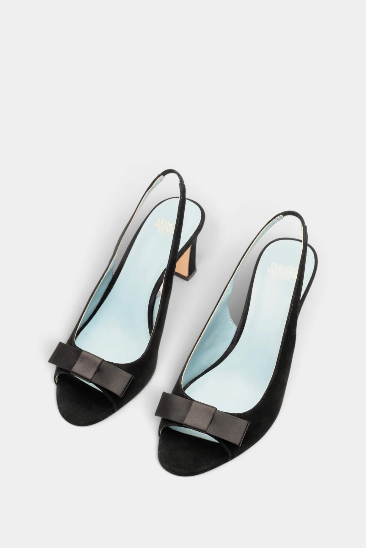The Copper Shed Reese black suede slingback heels with open-toe design and elegant bow detail on the vamp.