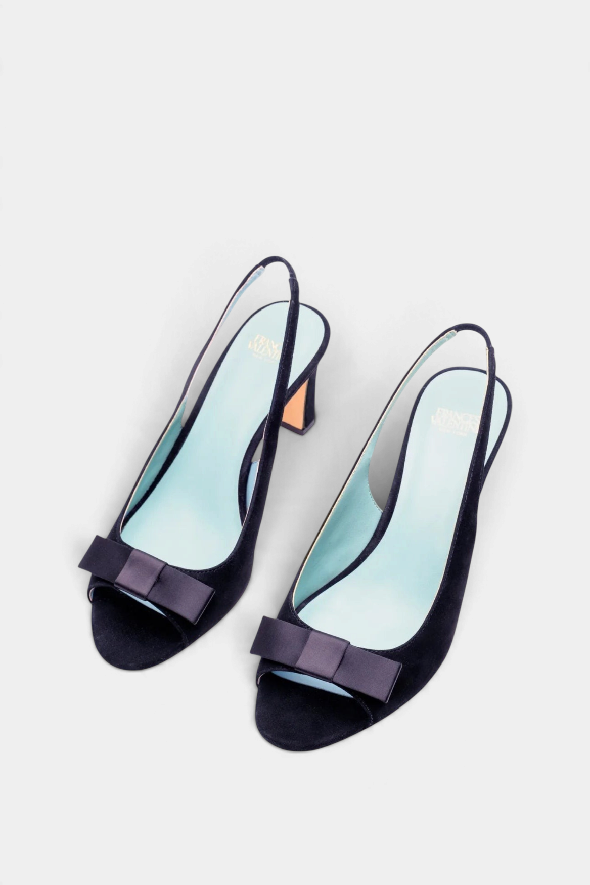 The Copper Shed Reese navy suede slingback heels featuring an open toe and elegant bow detail on the vamp.
