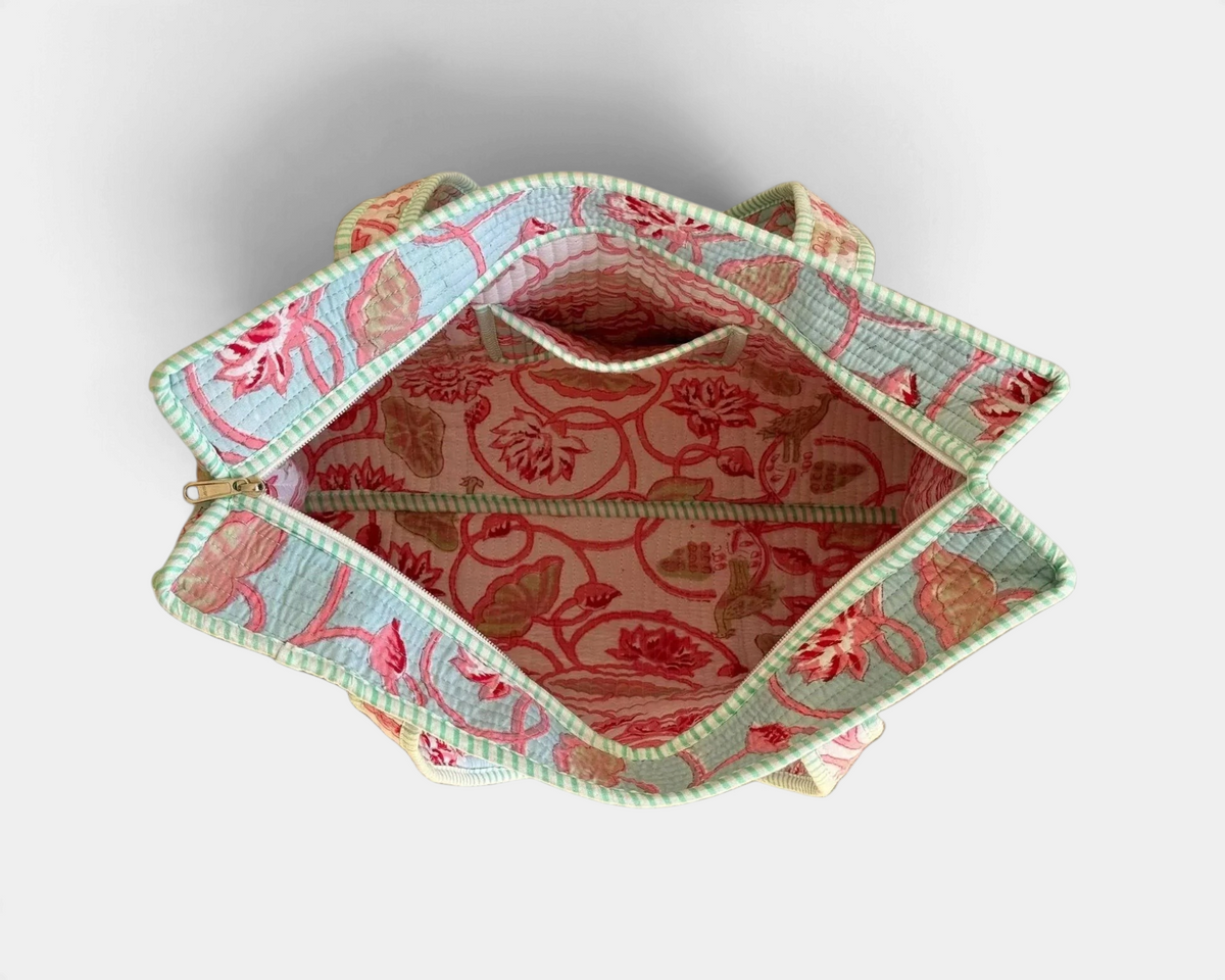 The Copper Shed reversible quilted cotton tote bag with a vibrant multicolor floral block print and interior pocket.