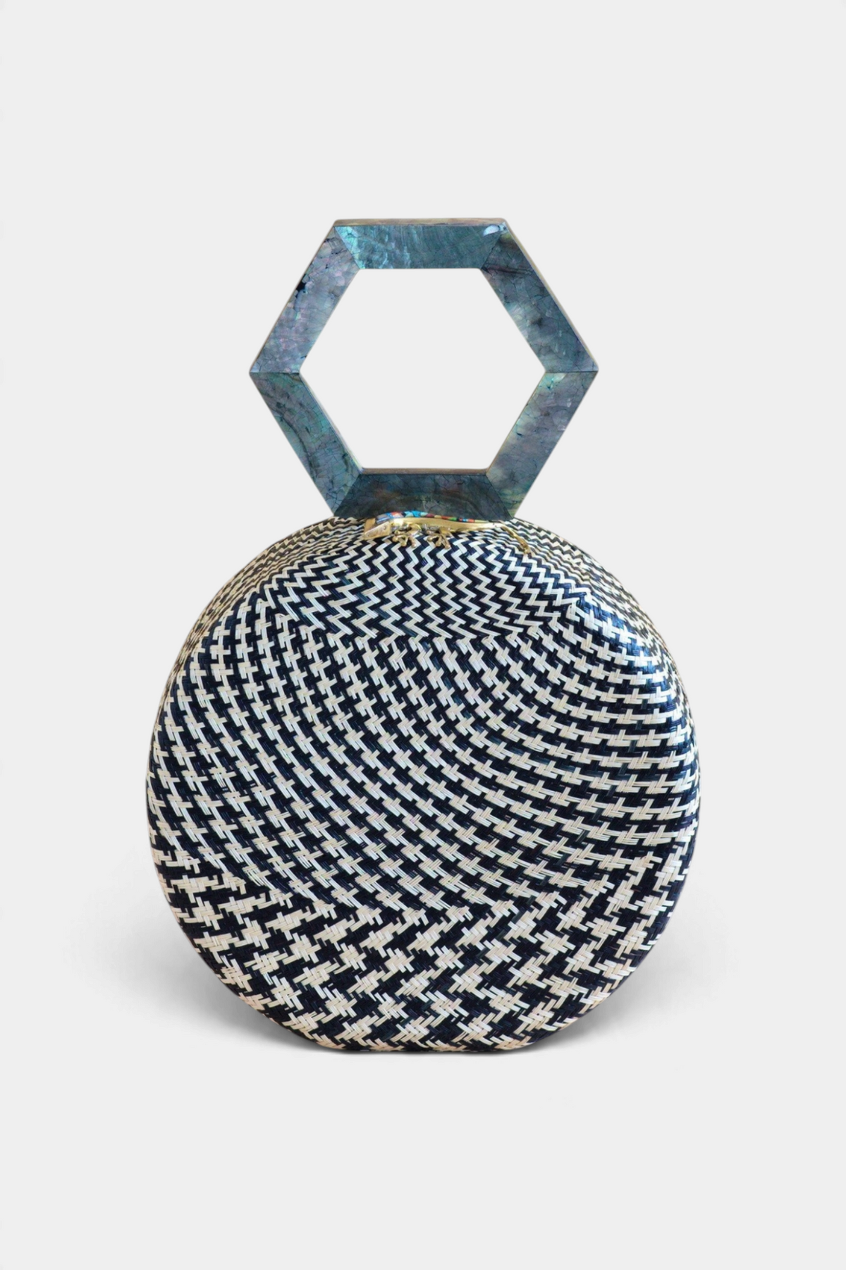 The Copper Shed black round handwoven buri palm handbag with a unique hexagonal mother of pearl handle
