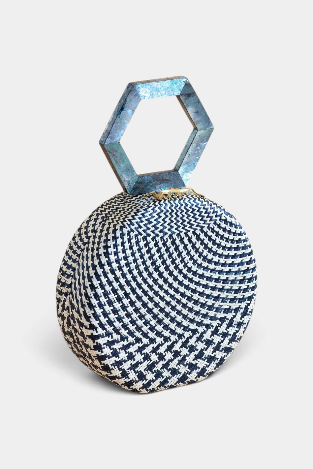 The Copper Shed round handwoven black buri palm handbag with a hexagon mother of pearl handle and lizard clasp