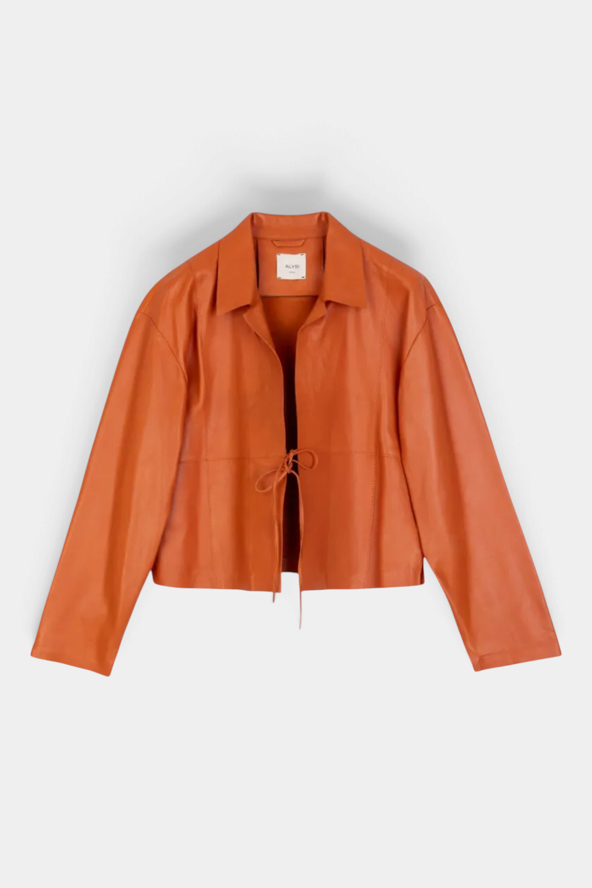 The Copper Shed short genuine leather jacket in rust orange with a classic collar, drawstring front, and flared sleeves