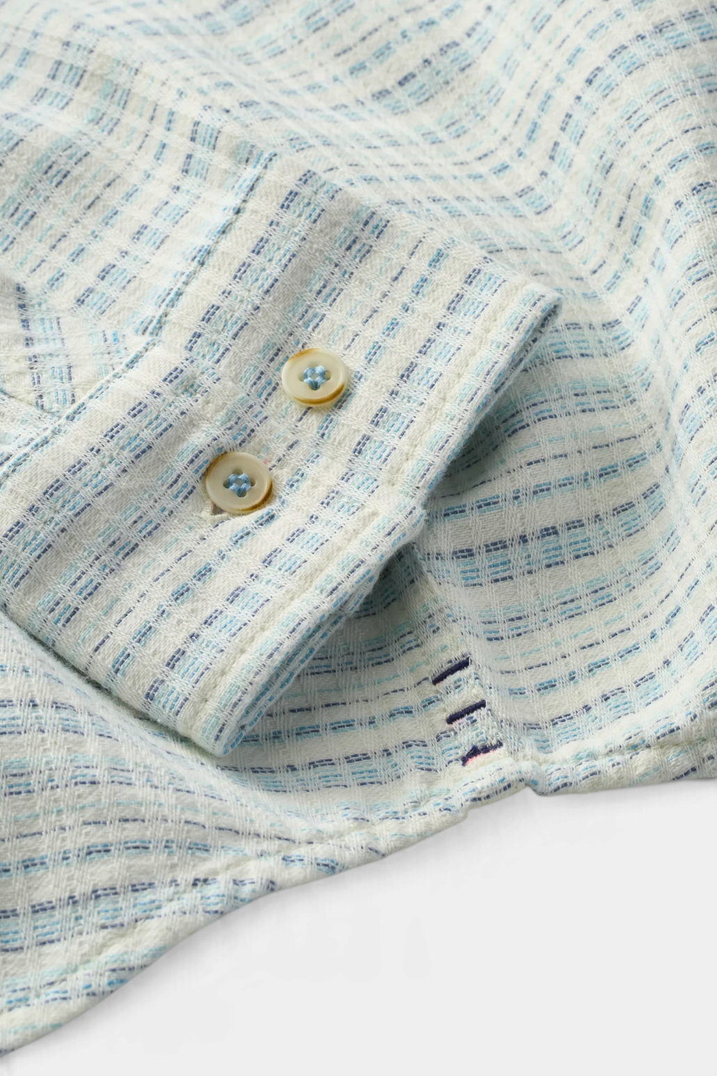 The Copper Shed Saltaire shirt cuff in white and blue striped organic cotton dobby with Corozo buttons