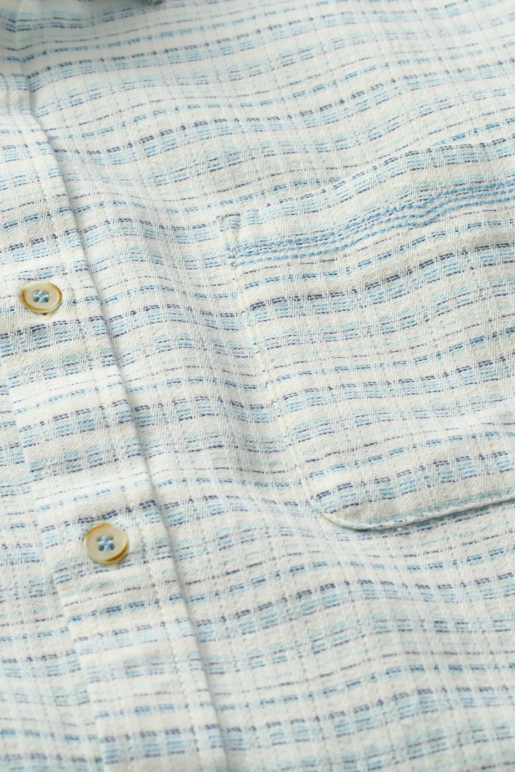 The Copper Shed Saltaire shirt in white and blue organic cotton dobby with a chest pocket and Corozo buttons