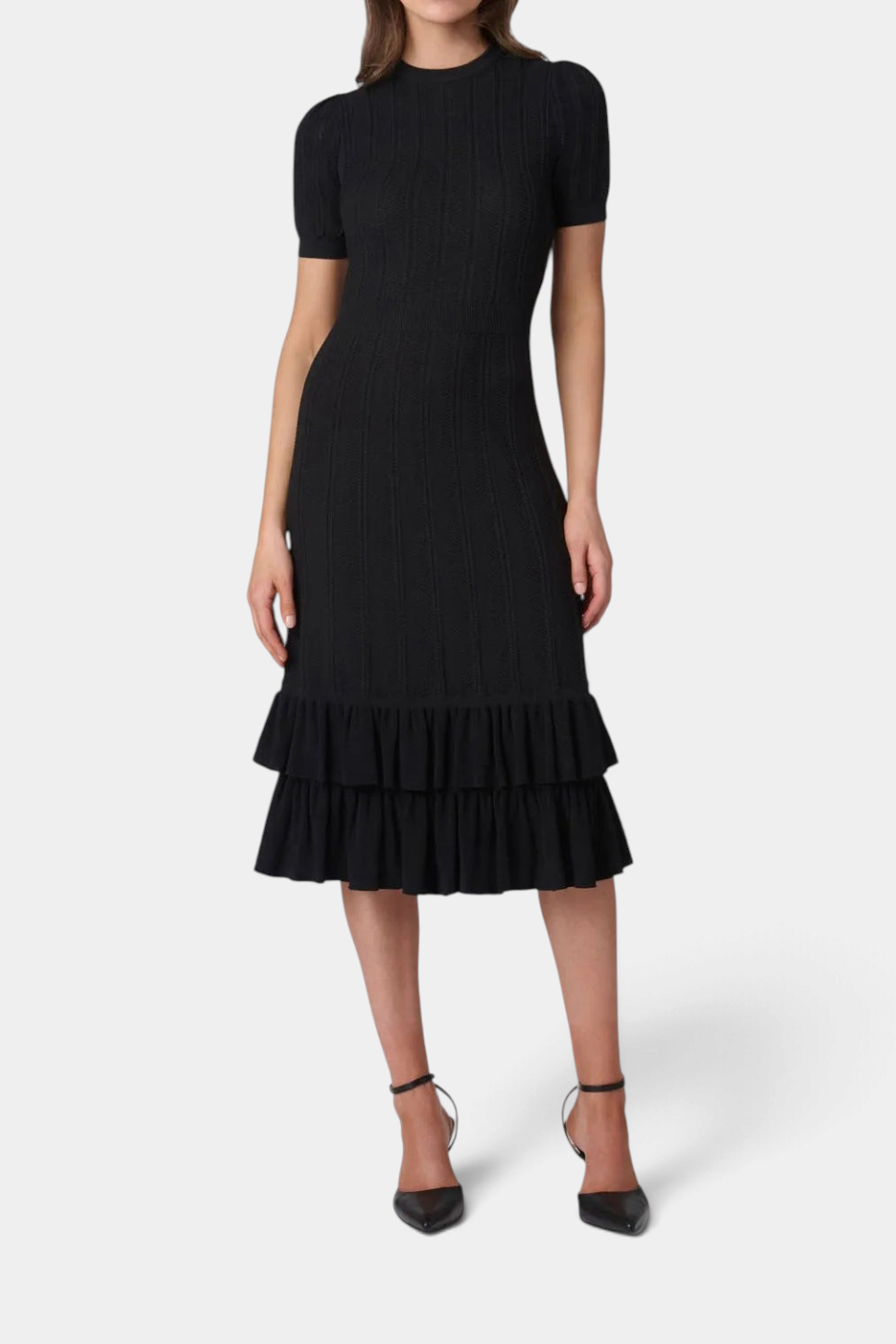 The Copper Shed Savannah black midi dress featuring a pointelle knit, puff sleeves, and a tiered ruffle hem.