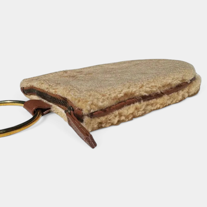 The Copper Shed cream shearling mini wristlet with brown leather trim and antique brass ring hardware