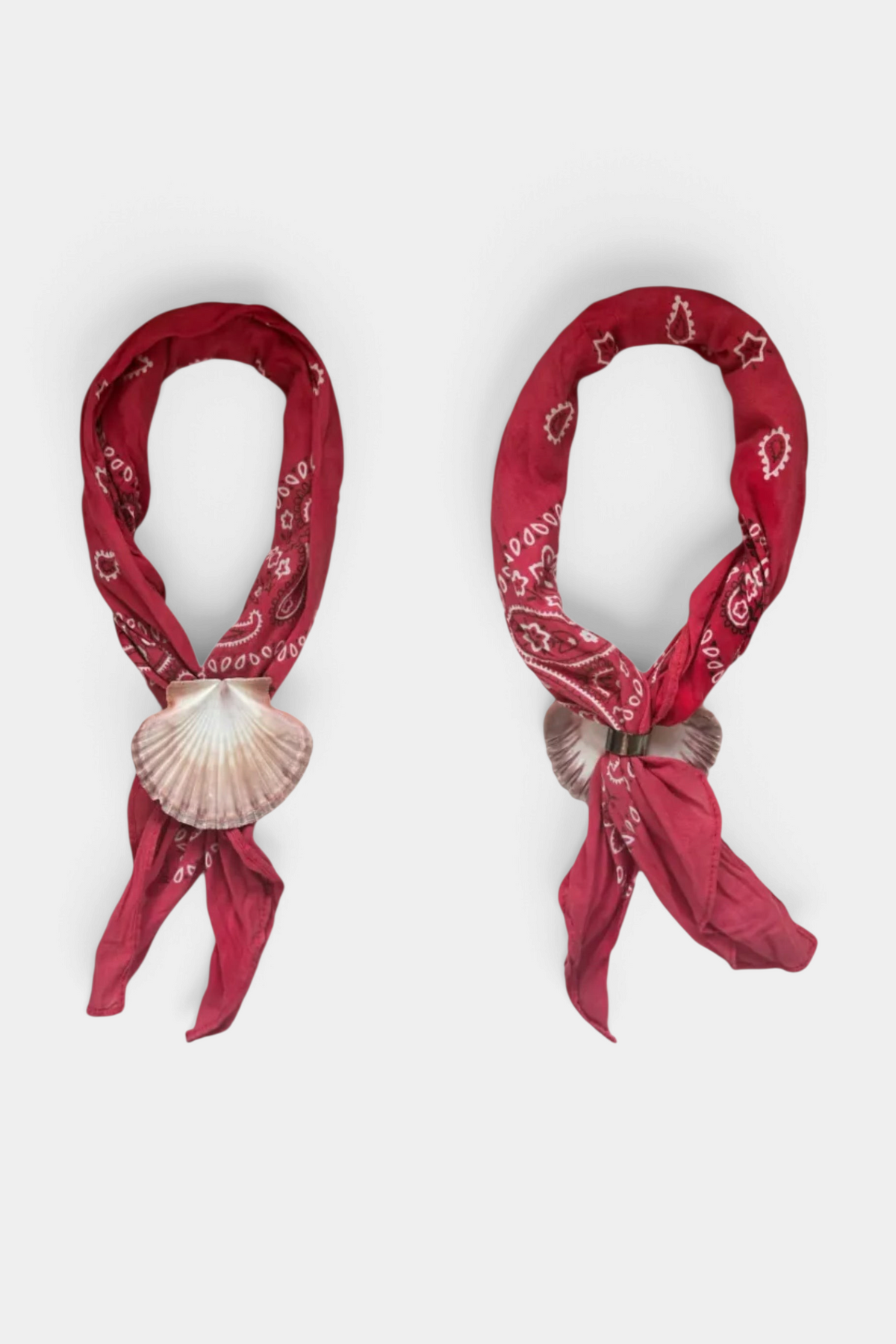 The Copper Shed Shell Yeah bandana ring tie featuring a natural scallop shell on a red paisley bandana.