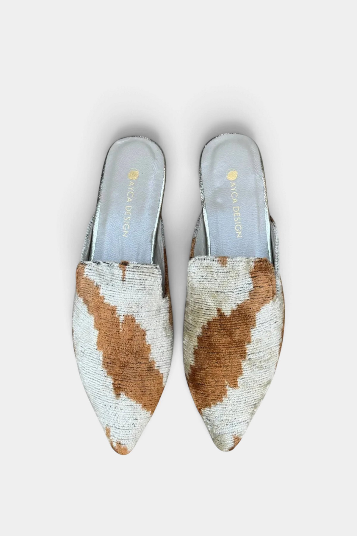 The Copper Shed silk velvet ikat pointed-toe slides in brown and cream with a leather-lined interior.
