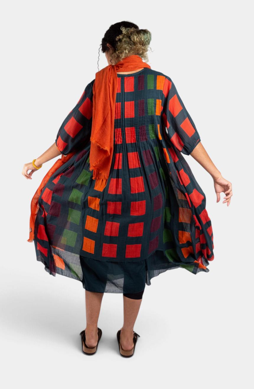 The Copper Shed Skye Dress in petrol with a multi-coloured block check pattern, 3/4 sleeves, and pleated cotton fabric.