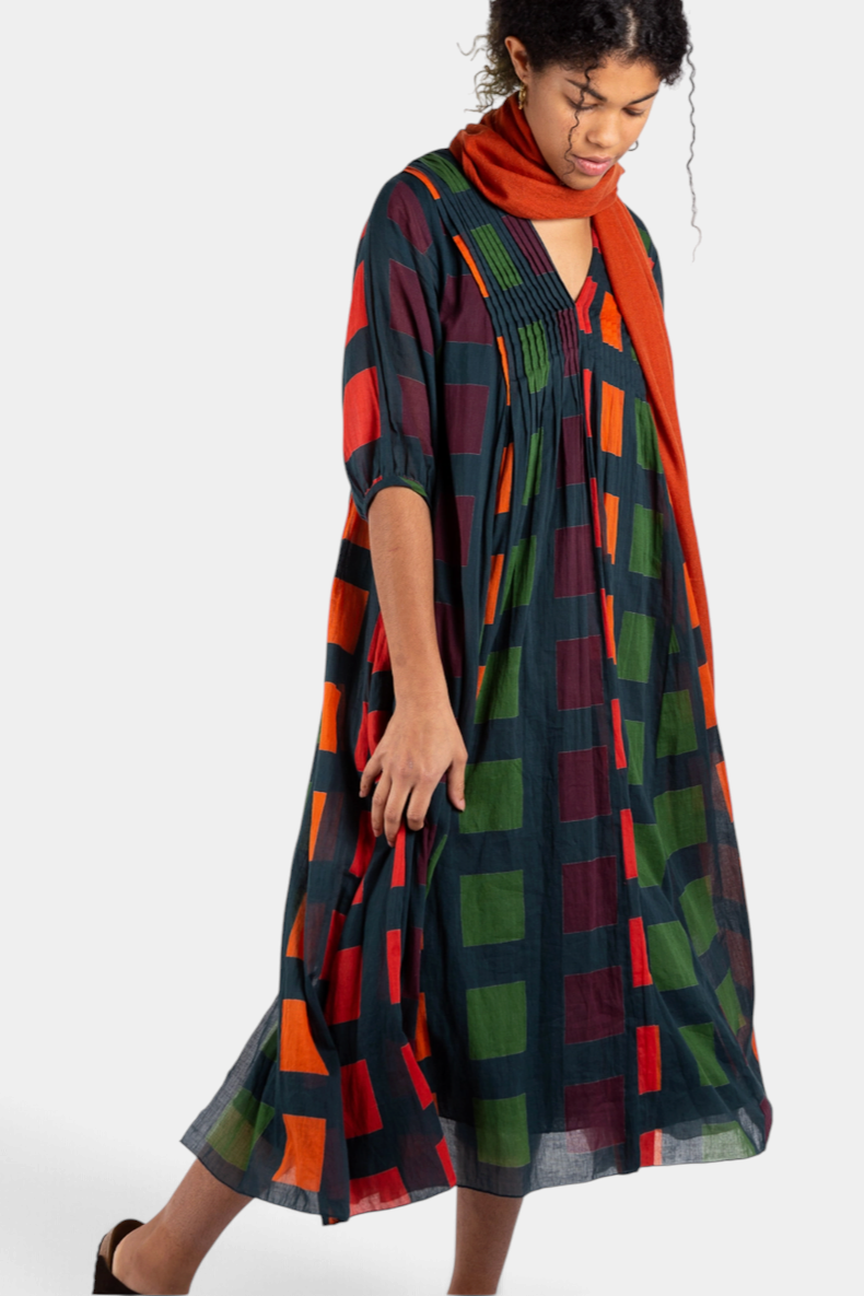 The Copper Shed Skye midi dress in petrol cotton with a geometric block pattern, pleated front, and 3/4 sleeves.