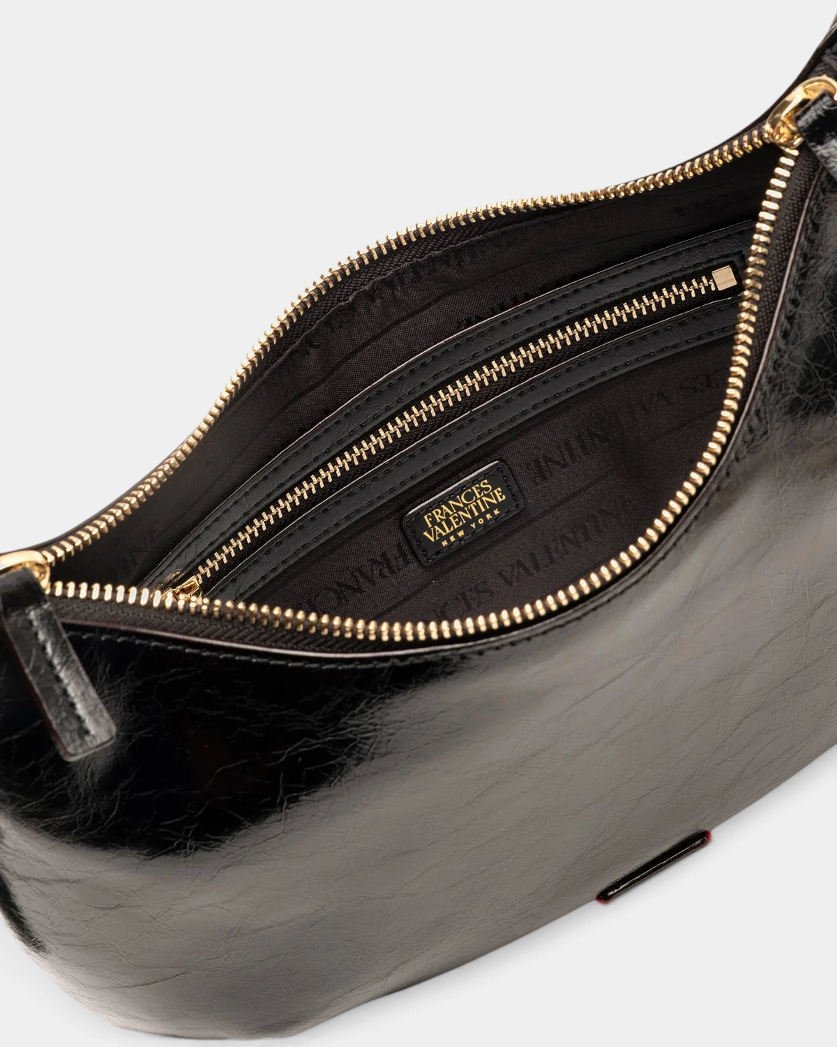The Copper Shed Starr hobo bag in black crinkled leather with a gold zipper and interior pocket detail.
