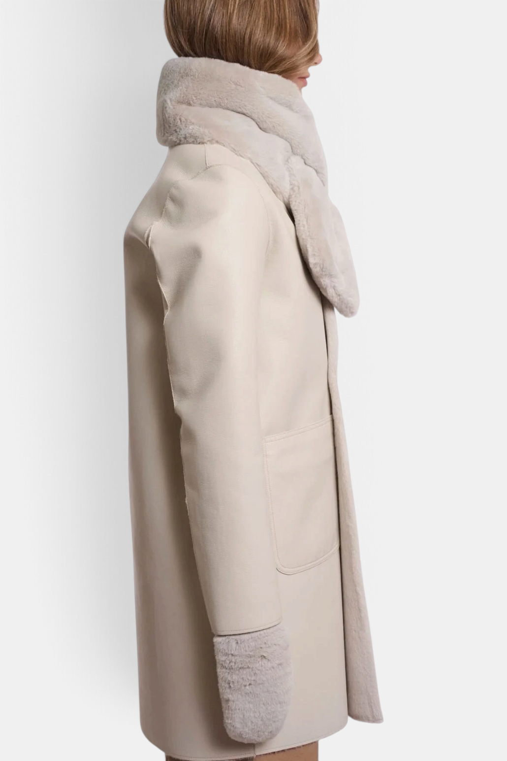 The Copper Shed Stip beige faux fur scarf worn over a matching coat, showing the soft texture and open detail.