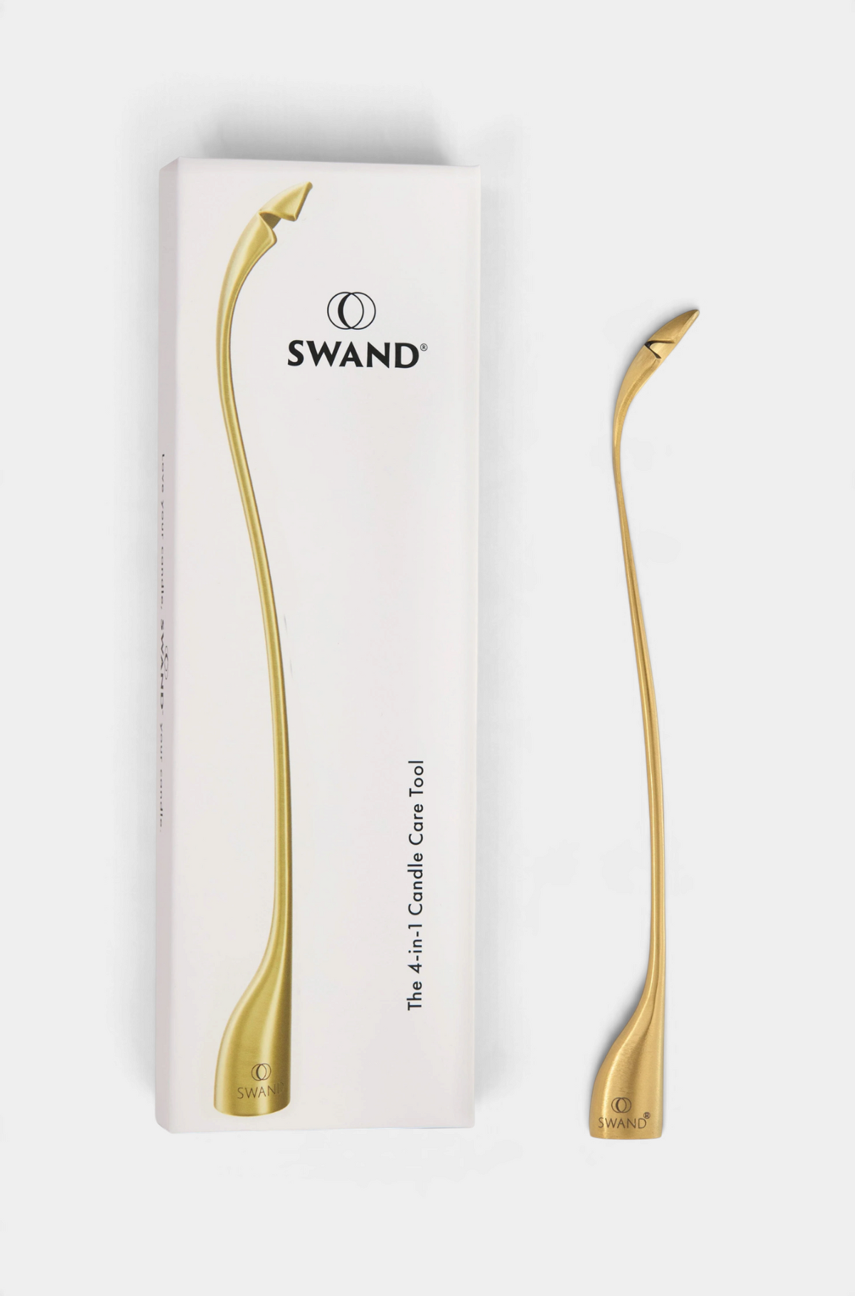 The Copper Shed SWAND 4-in-1 gold candle care tool with its white product packaging box