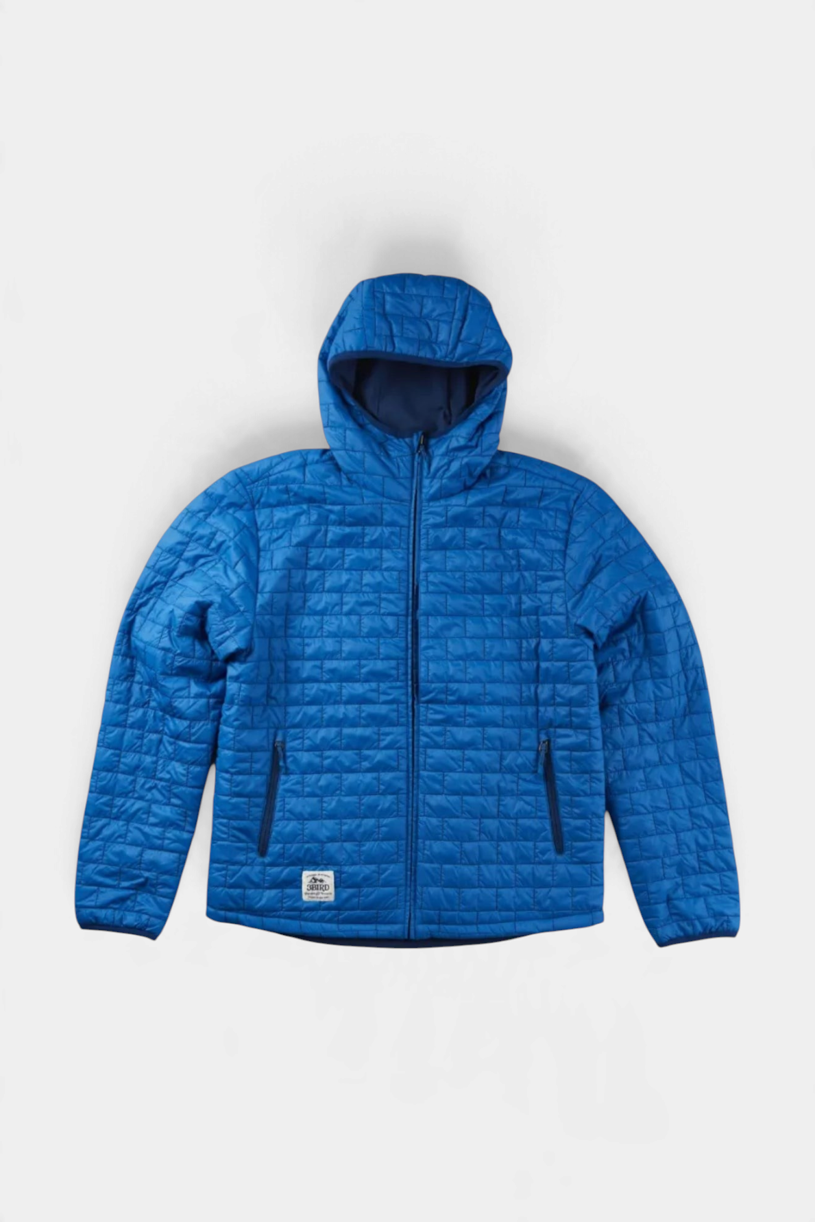 The Copper Shed Switch insulated hooded jacket in blue, featuring a quilted recycled nylon exterior and zip pockets.