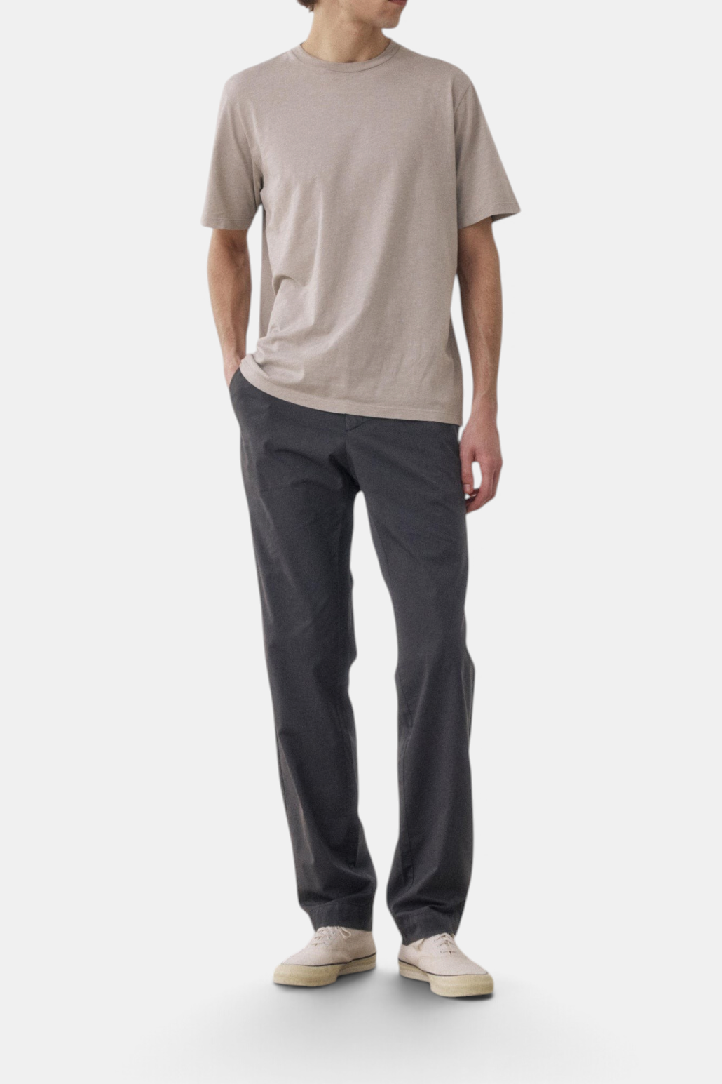 The Copper Shed Taylor chino pants in dark grey cotton with a straight-leg fit, worn with a beige t-shirt.