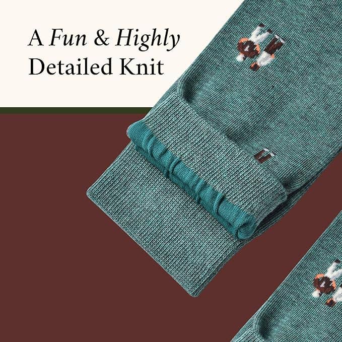 The Copper Shed novelty socks in teal cotton featuring a detailed knitted coach pattern with whistle and clipboard.