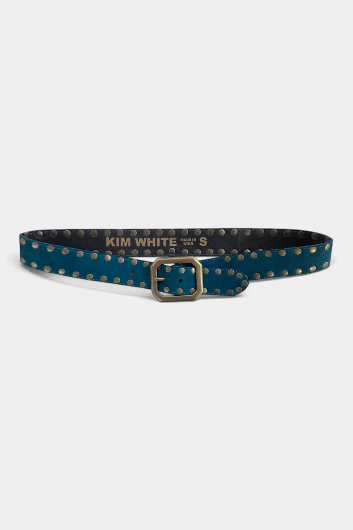The Copper Shed teal suede belt featuring a squared-off buckle and decorative brass studs along the strap.