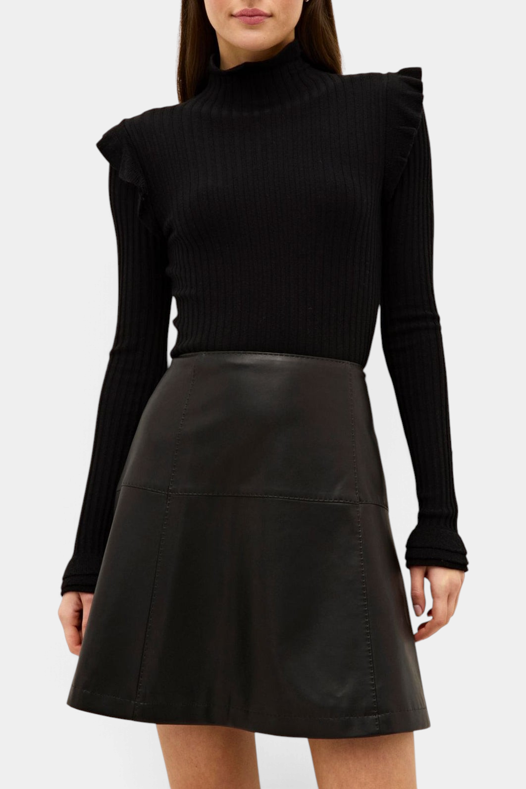 The Copper Shed Tinley black ribbed turtleneck sweater featuring ruffle trim on the shoulders and cuffs.