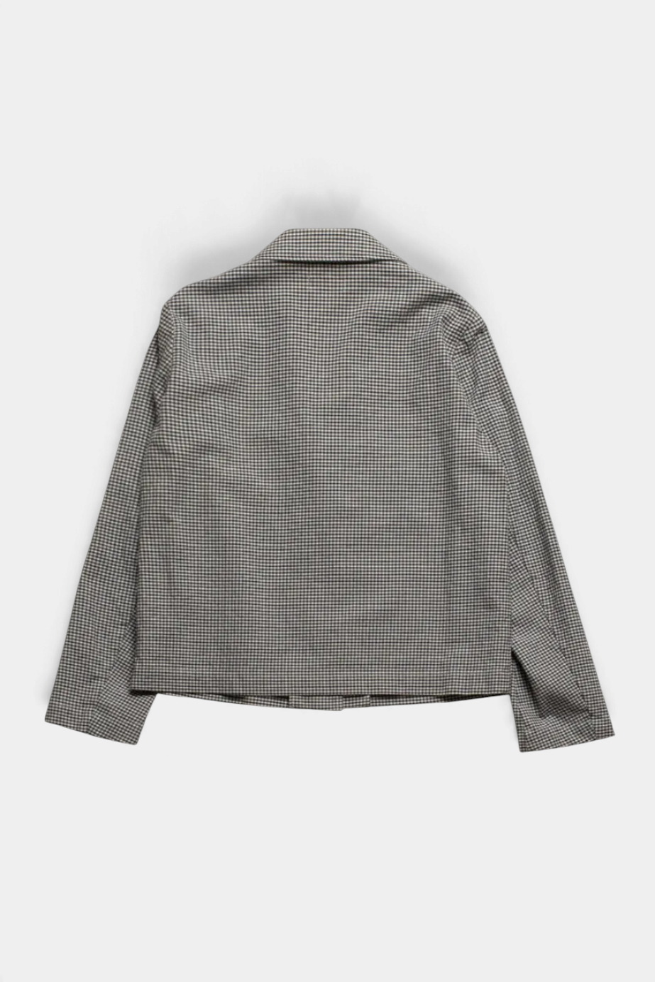 The Copper Shed Vizir jacket in a grey and white gingham check pattern, featuring a short blazer-inspired cut.