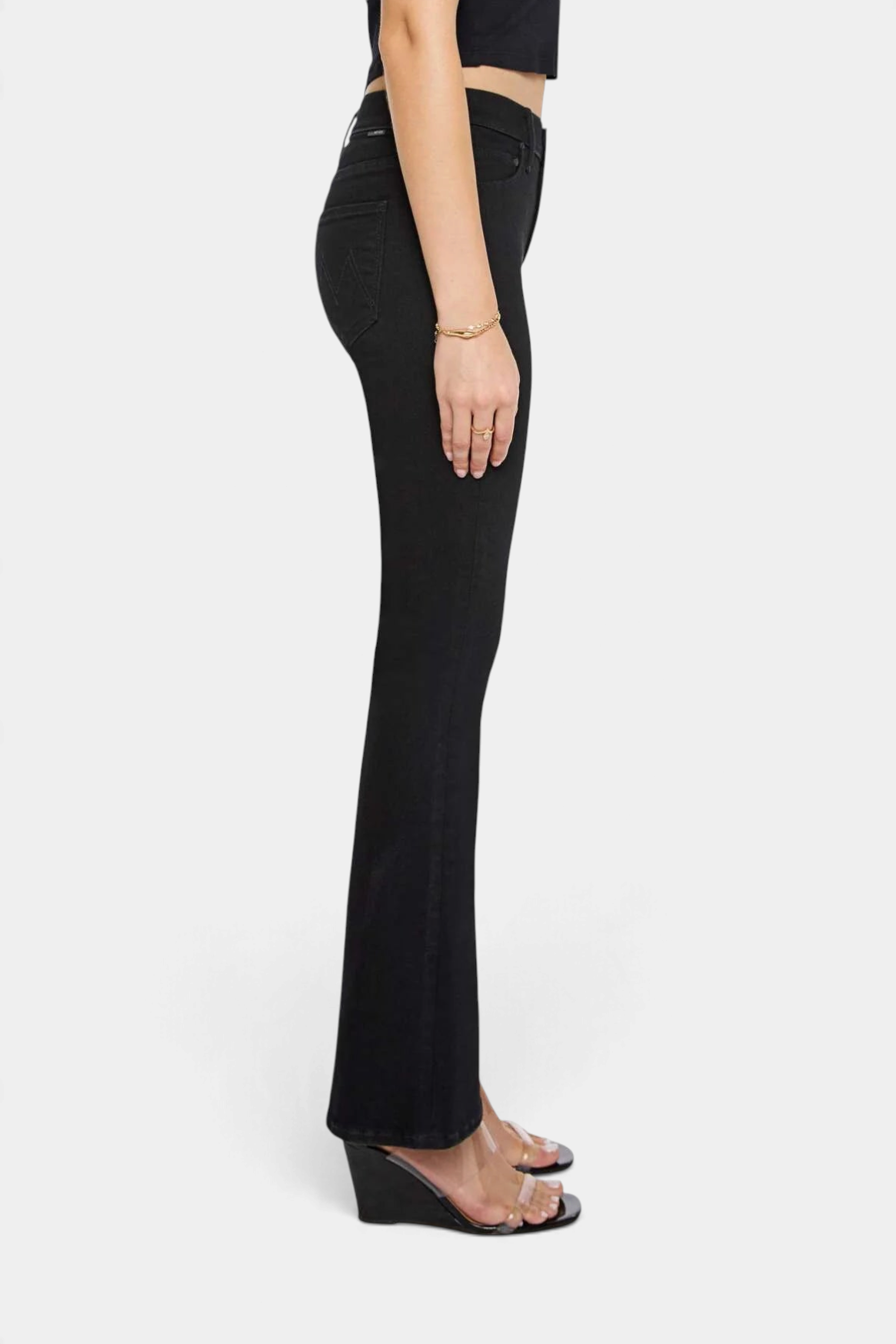 The Copper Shed The Weekender mid-rise black flare jeans with a clean hem, shown from a side profile view.