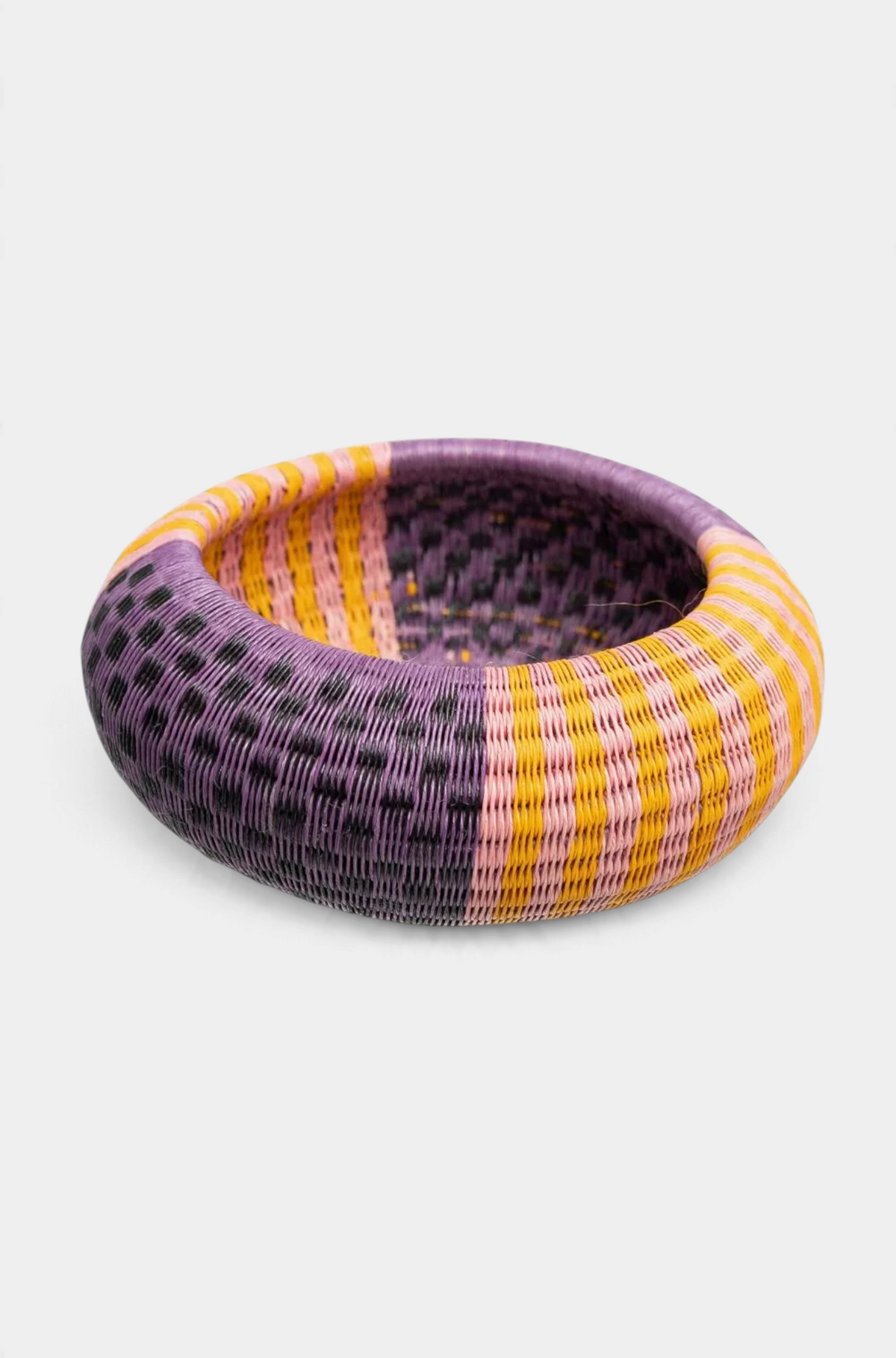 The Copper Shed handwoven Werregue bracelet in purple, yellow, and pink natural palm fiber with copper thread details.