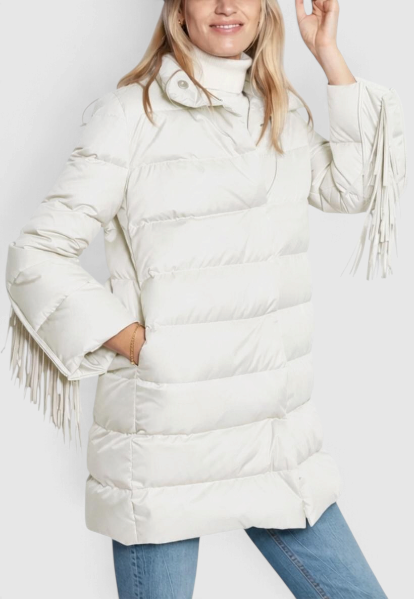The Copper Shed white down car coat with removable fringe sleeves and hidden snap closure worn by a blonde model