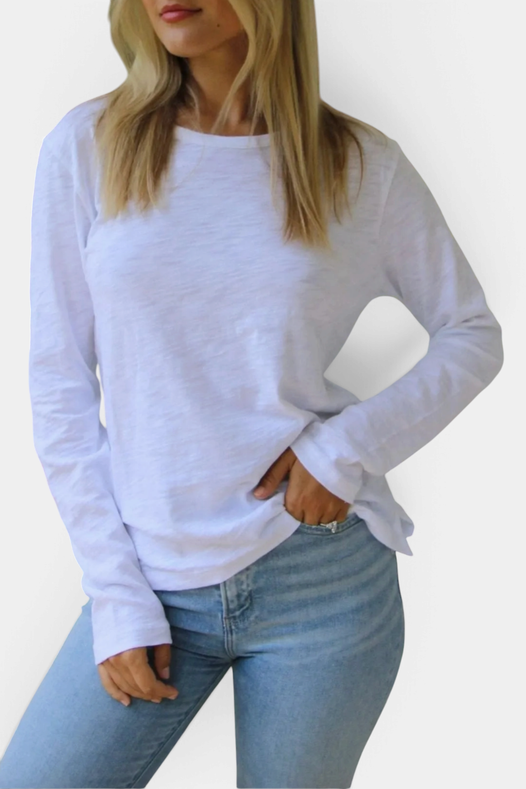 Woman wearing The Copper Shed white long sleeve Pima cotton slub crew neck tee tucked into light wash jeans