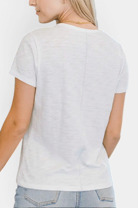 The Copper Shed white short sleeve Pima cotton slub tee worn by a woman, showing the back view with a center seam.