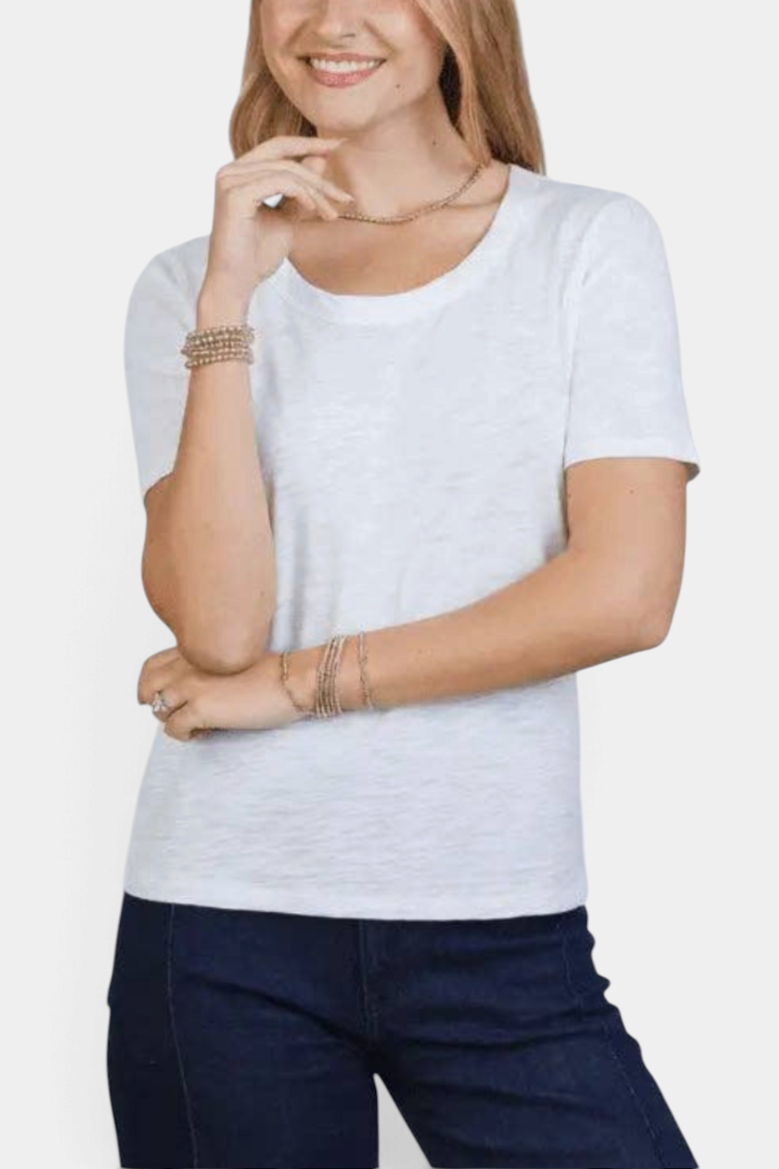 The Copper Shed white Pima cotton short sleeve tee with scoop neckline and gathered shoulders on a smiling woman