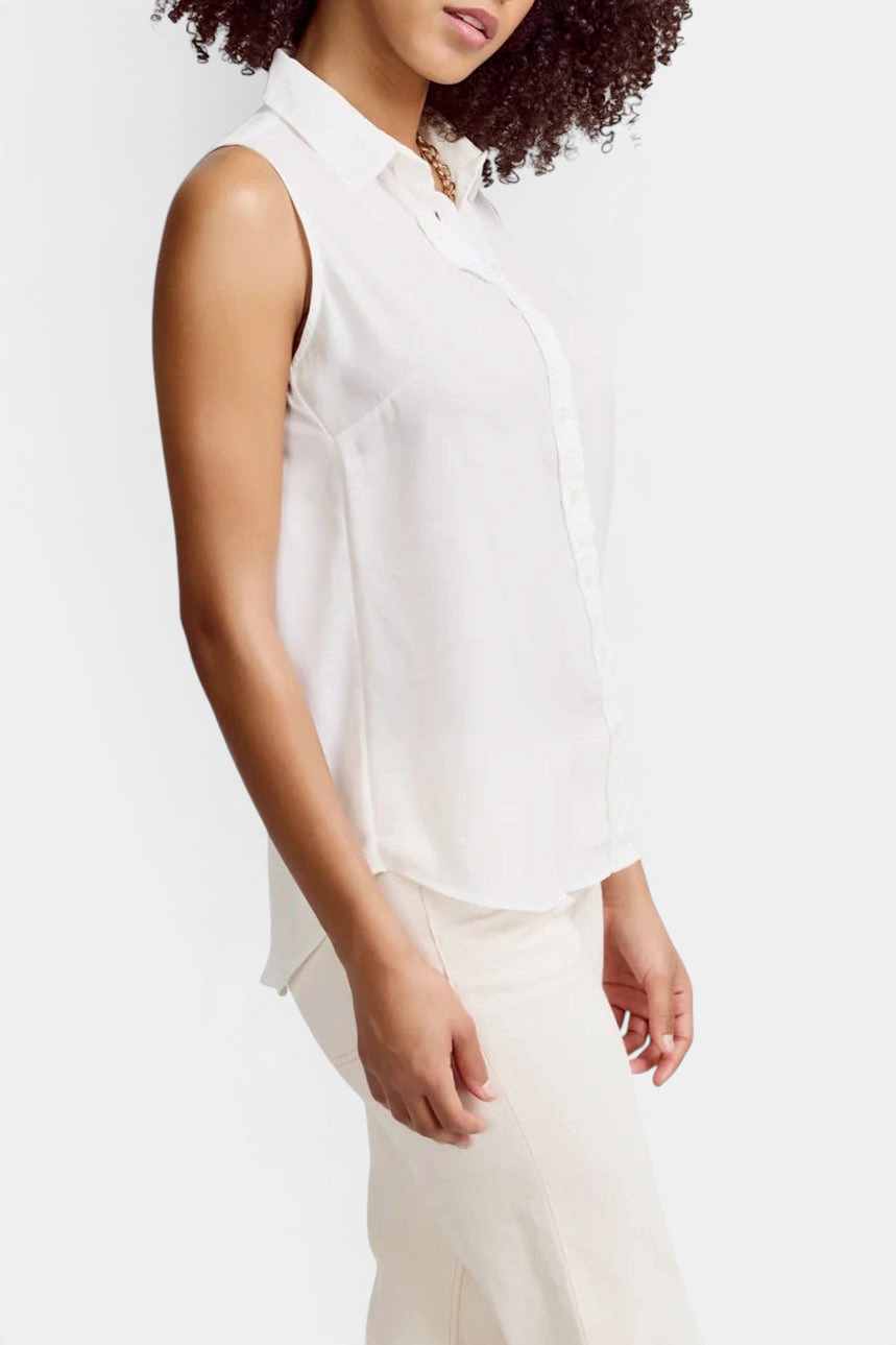 Model wearing The Copper Shed white sleeveless button-down shirt in textured poly crepe with narrow armholes