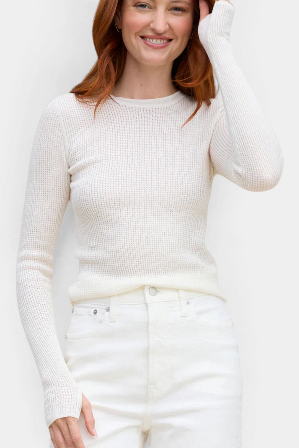 The Copper Shed Shirttail Waffle Crew in white cotton with long sleeves, thumbholes, and a curved hem on a model.