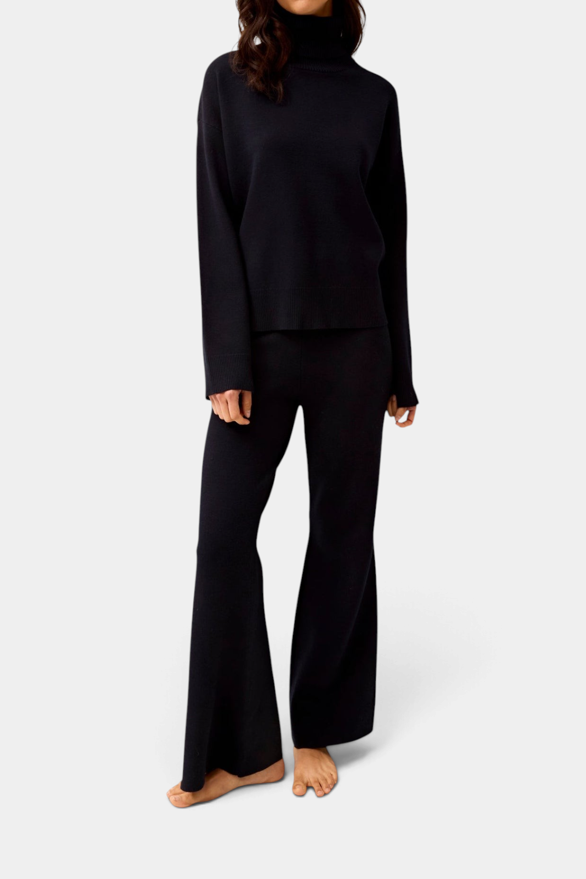 Model wearing The Copper Shed black knit Winnie boot-leg pants with an elastic waistband and matching sweater