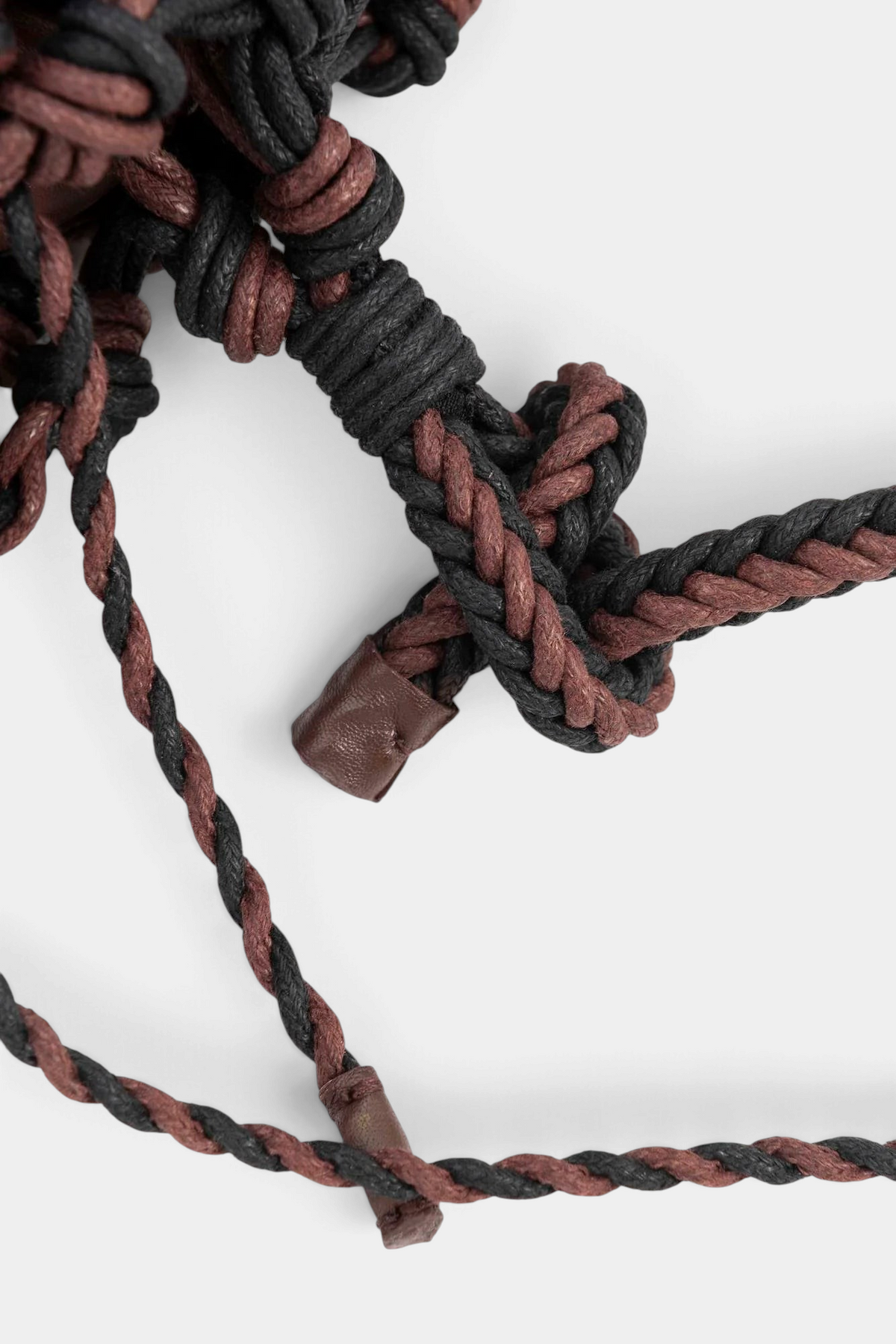 The Copper Shed hand-woven black and brown cotton tube shoulder strap detail on a white background